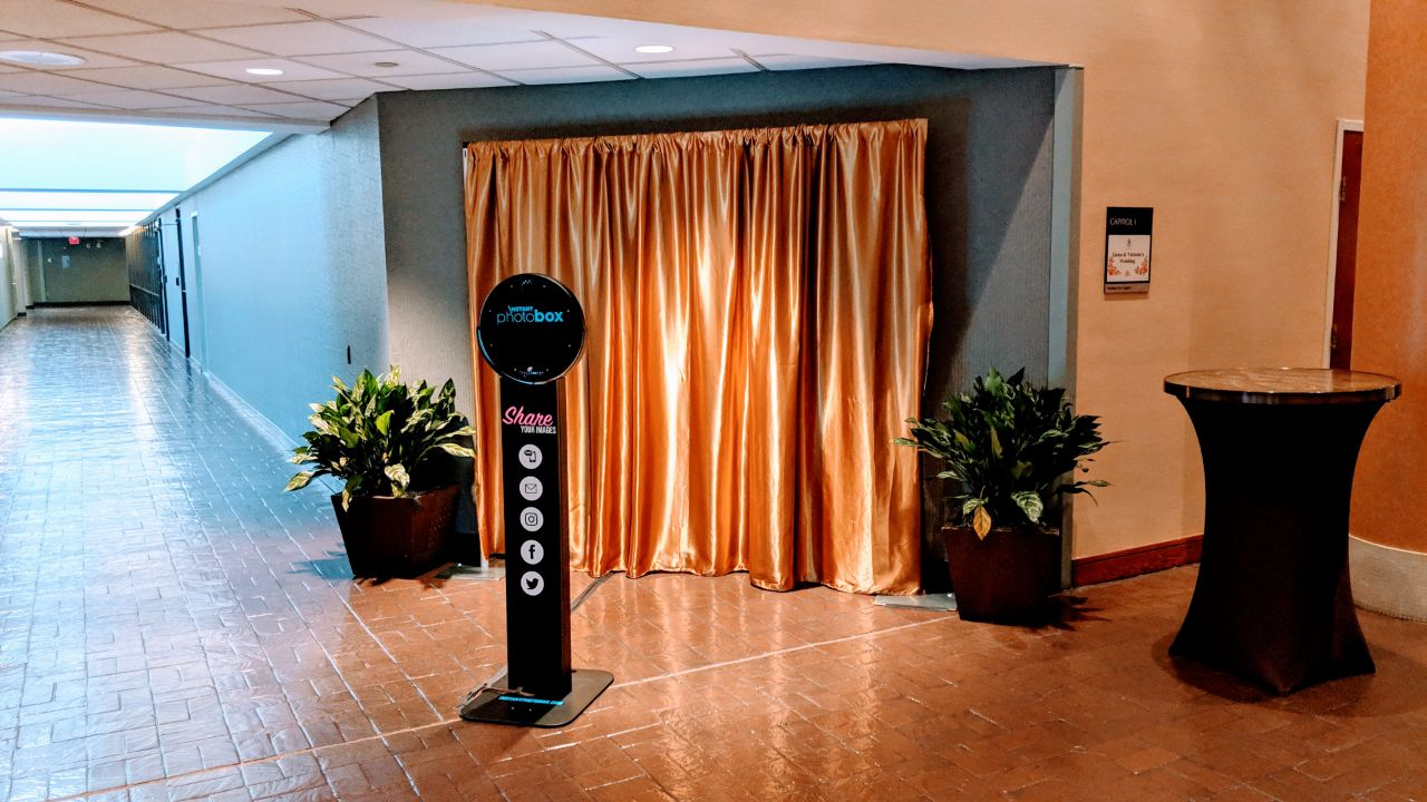 Instant Photo Box selfie station set up at an event venue